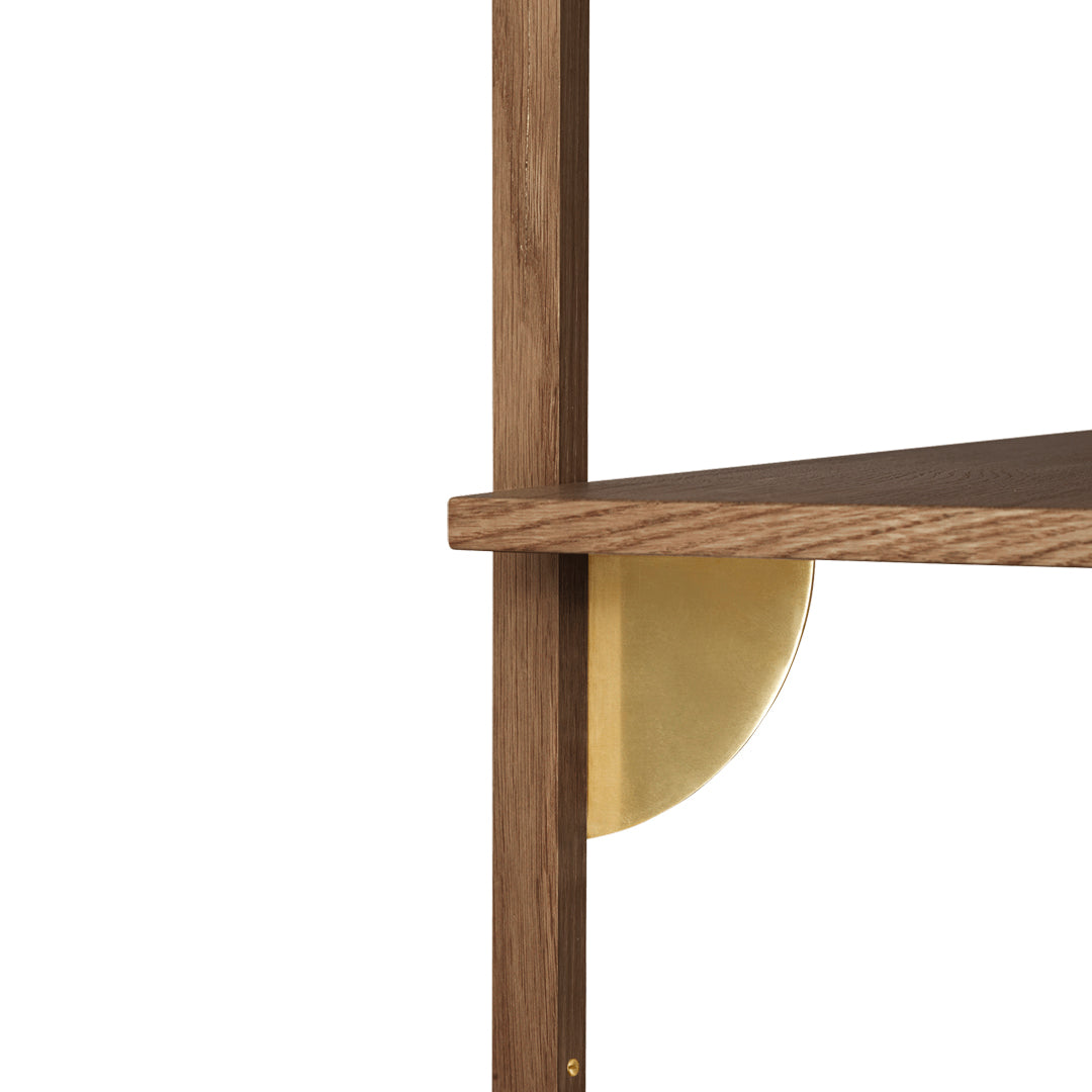 Walnut shelf with smooth wood grain and a circular gold bracket detail, blending warm tones and metallic accents.
