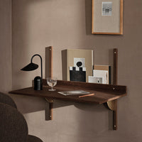 "Modern wood wall shelf in rich brown, featuring sleek lines and minimalistic design against a warm beige background."