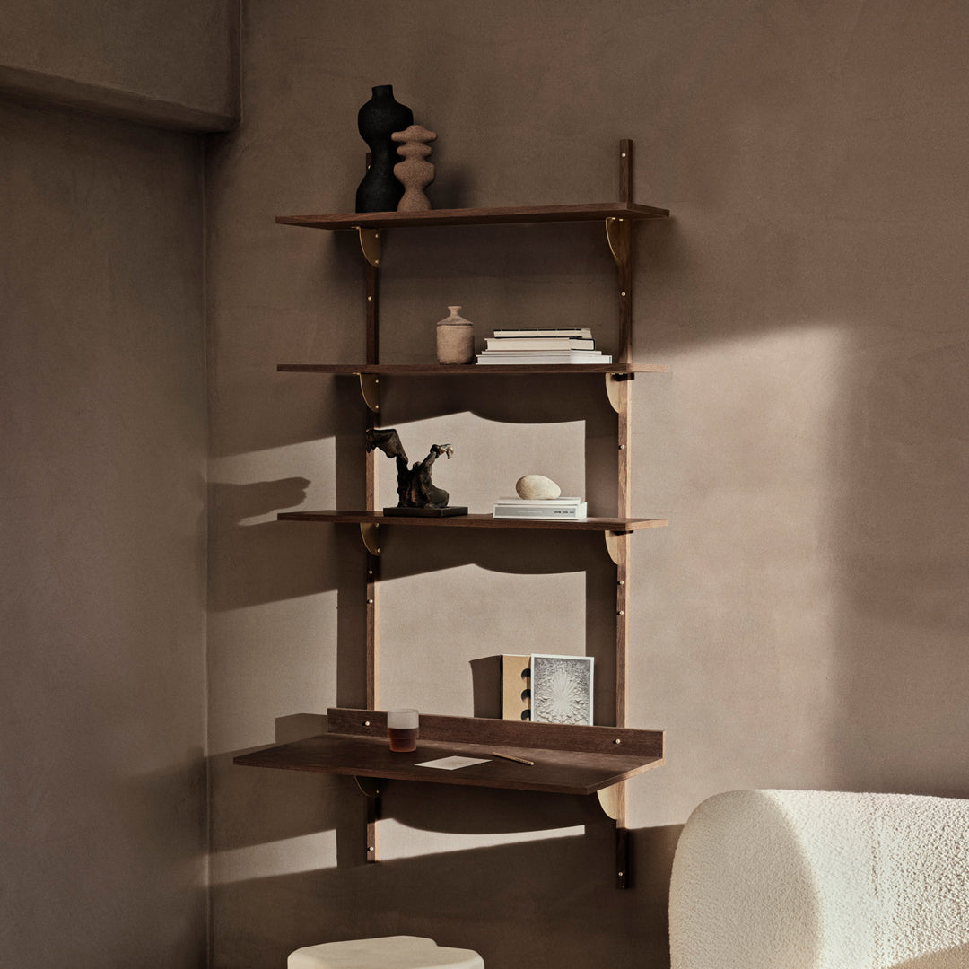 Wooden wall shelf with warm tones and smooth surfaces, featuring elegant brass brackets and minimalist decor accents.