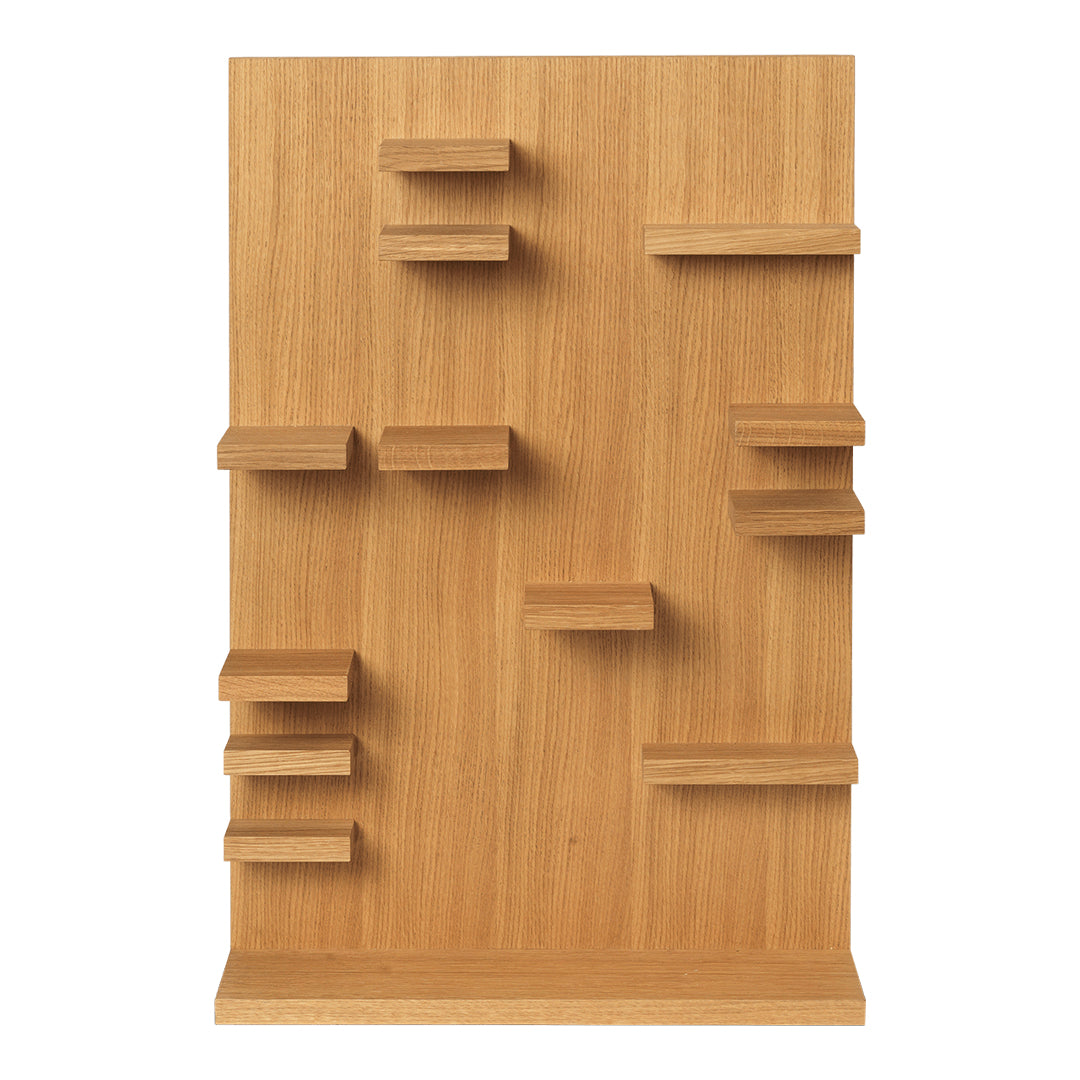 Wooden shelving unit in natural oak finish with an asymmetrical pattern of shelves in varying sizes.