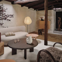Modern living room with neutral tones, earthy textures, soft curves, and minimalist patterns in a cozy, inviting space.
