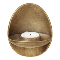 Egg-shaped bronze candle holder with a textured finish and a smooth, white candle. Elegant golden hues and modern design.