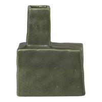 Green ceramic vase with a unique geometric shape and textured finish. Ideal for modern decor.
