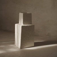 Textured beige vase with minimalistic geometric shapes, showcasing a subtle, earthy color palette.