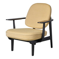 Stylish beige upholstered chair with a sleek black wooden frame. Modern design and minimalistic pattern.