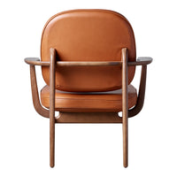 Brown leather chair with a smooth finish and minimalist wooden frame, showcasing a sleek and modern design.