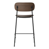Brown wooden backrest bar stool with black metal legs, featuring a sleek, minimalist design. Perfect for modern decor.