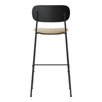 Black metal chair with a natural wood seat, featuring a sleek minimalist design and clean lines.