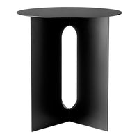 Black modern side table with a circular top and a unique cut-out pattern on the base.