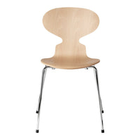 Light wood chair with a smooth grain pattern and chrome legs, featuring a minimalist design and natural finish.