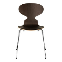 Dark brown wooden chair with smooth curves and chrome legs, featuring a minimalist design.