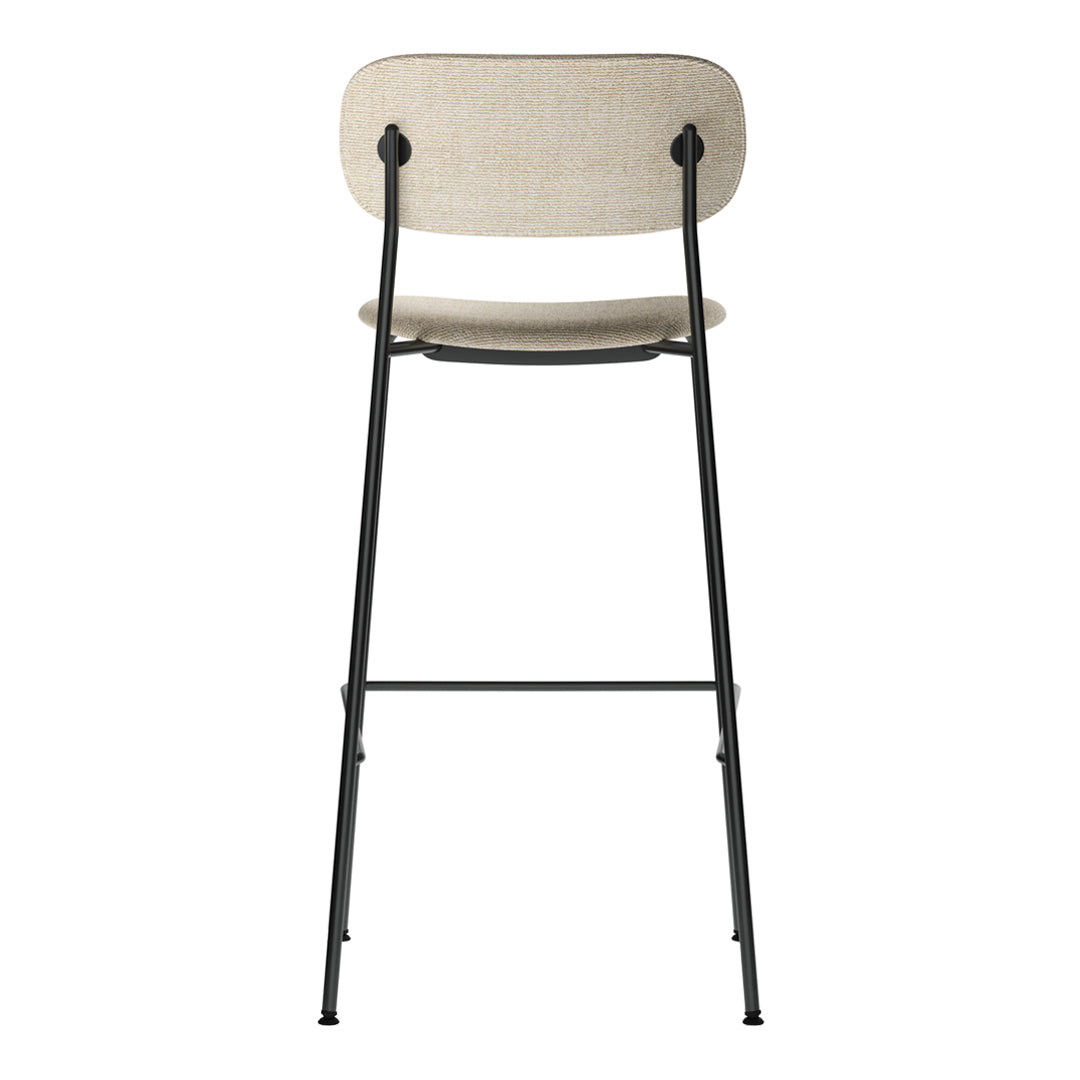 Beige fabric bar stool with a sleek black metal frame, featuring minimalistic design and subtle textures.