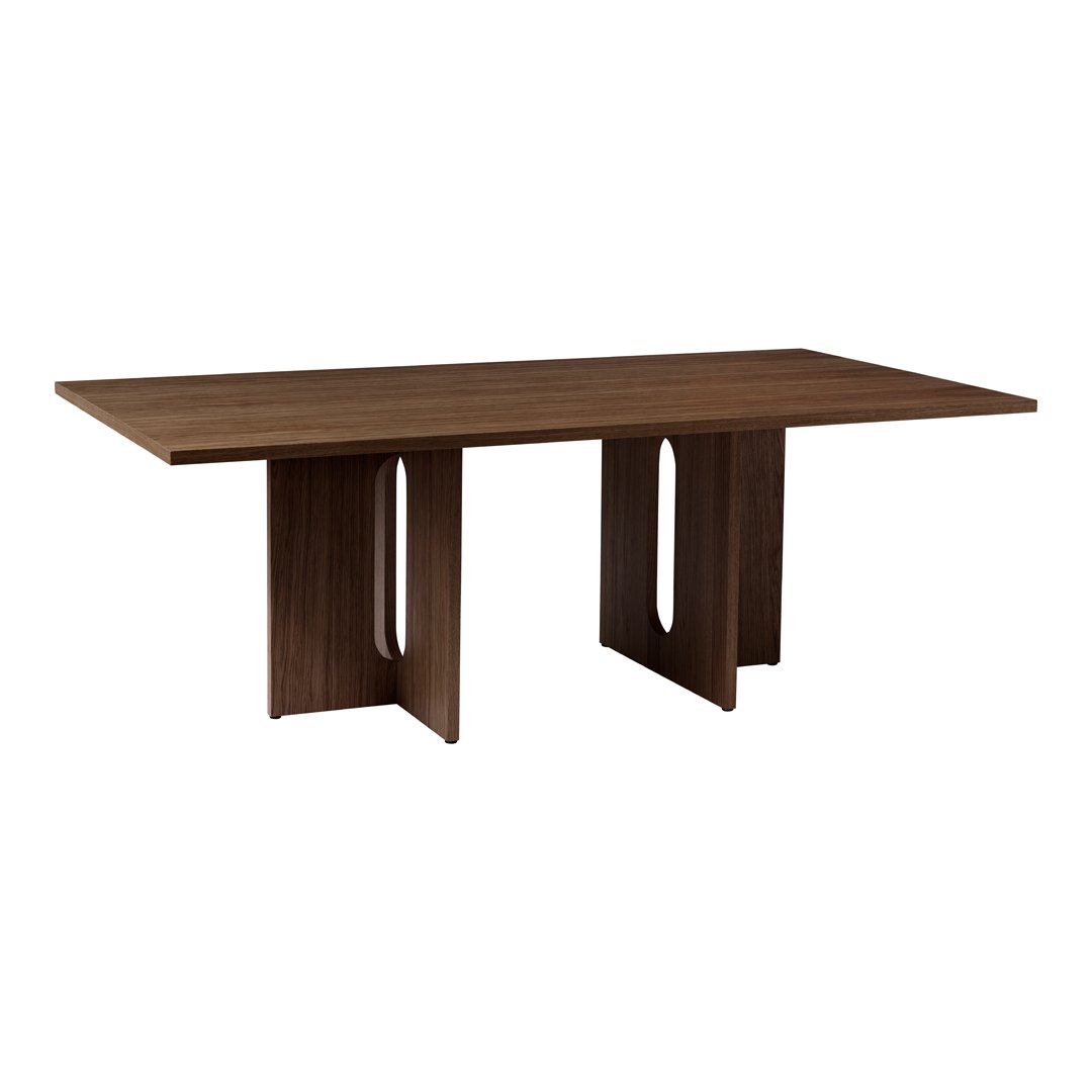 Brown wooden dining table with a smooth finish and modern cutout patterns on the base. Ideal for contemporary decor.