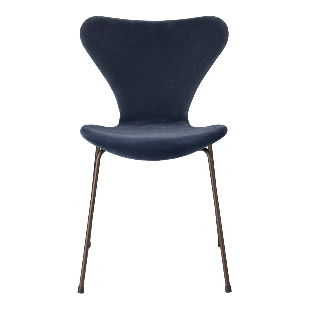 Navy blue chair with a unique butterfly shape and sleek metal legs. Soft, solid color with a modern design.