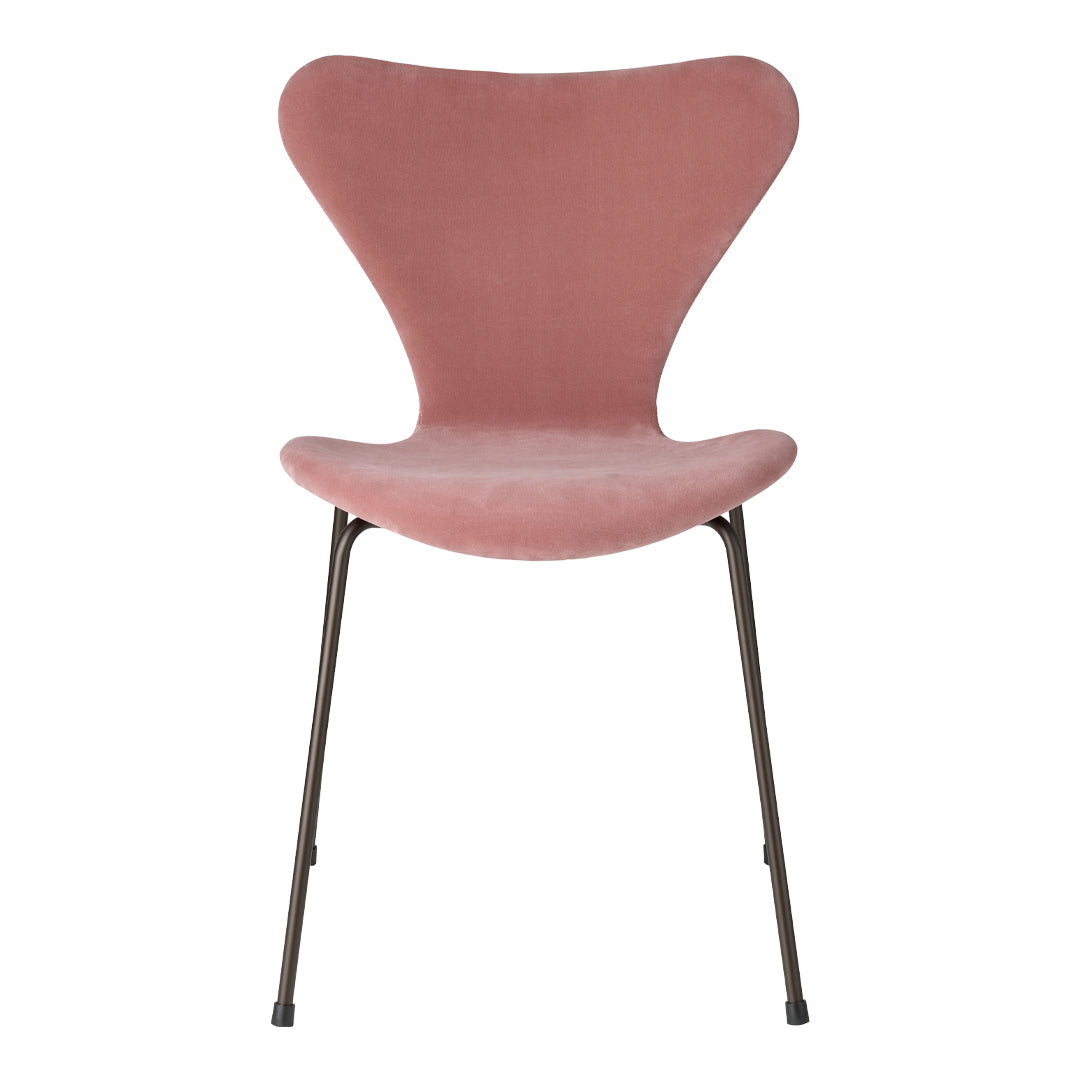 Pink velvet chair with a unique butterfly shape and sleek metal legs. Perfect for modern decor.