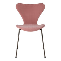 Pink velvet chair with a unique butterfly shape and sleek metal legs. Perfect for modern decor.