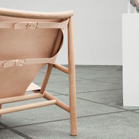 Light pink leather with beige wooden frame, featuring a minimalist design and natural textures.