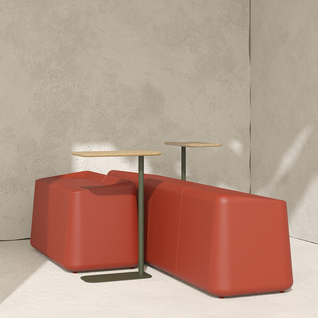 Modern two-piece sofa in deep red with minimalist wooden tables on a neutral backdrop. Smooth, geometric design.