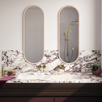Marble countertop with rich purple and white veins, featuring sleek oval mirrors and golden accents. Elegant modern design.