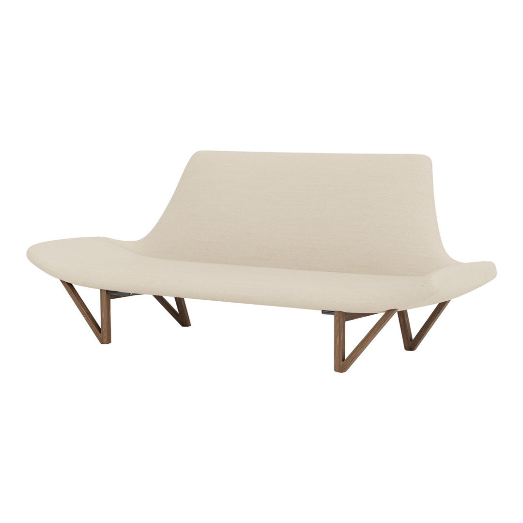 Beige modern sofa with smooth, curved lines and wooden legs, creating a minimalist and stylish aesthetic.