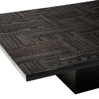 Textured dark wood tabletop with intricate patterns in deep brown tones, adding a chic, modern aesthetic.