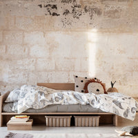 "Earthy tones with intricate paisley patterns on a soft bedding set, complementing natural wood furniture."
