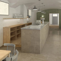 Modern café interior featuring a concrete bar, wood shelves, and a muted green accent wall in a minimalist design.