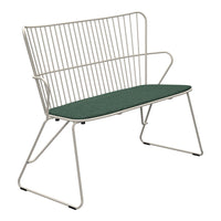 Modern white wire bench with a solid green cushion, featuring sleek lines and minimalistic design. Stylish and contemporary.