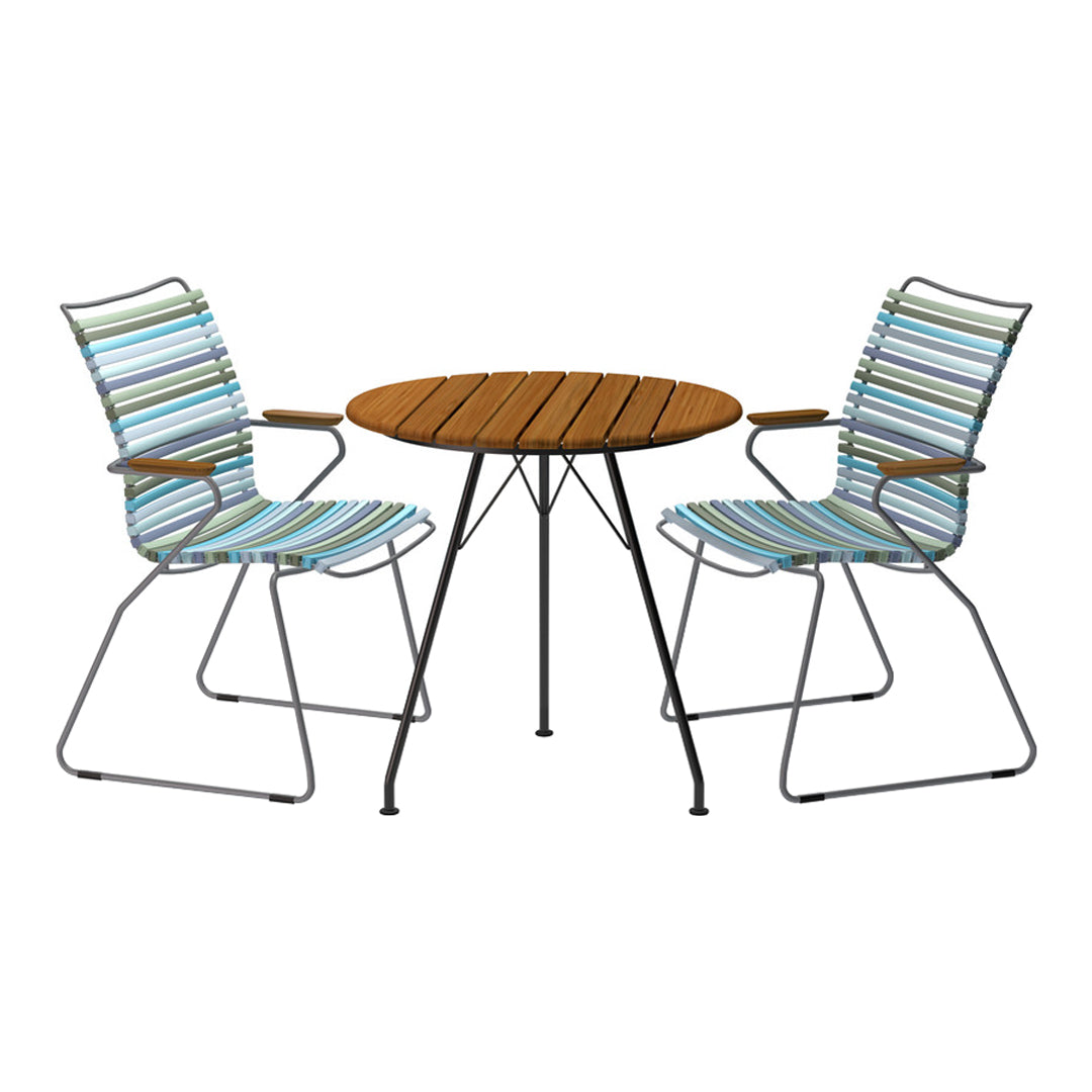 Striped blue and white chairs paired with a natural wood table, creating a vibrant outdoor dining set.