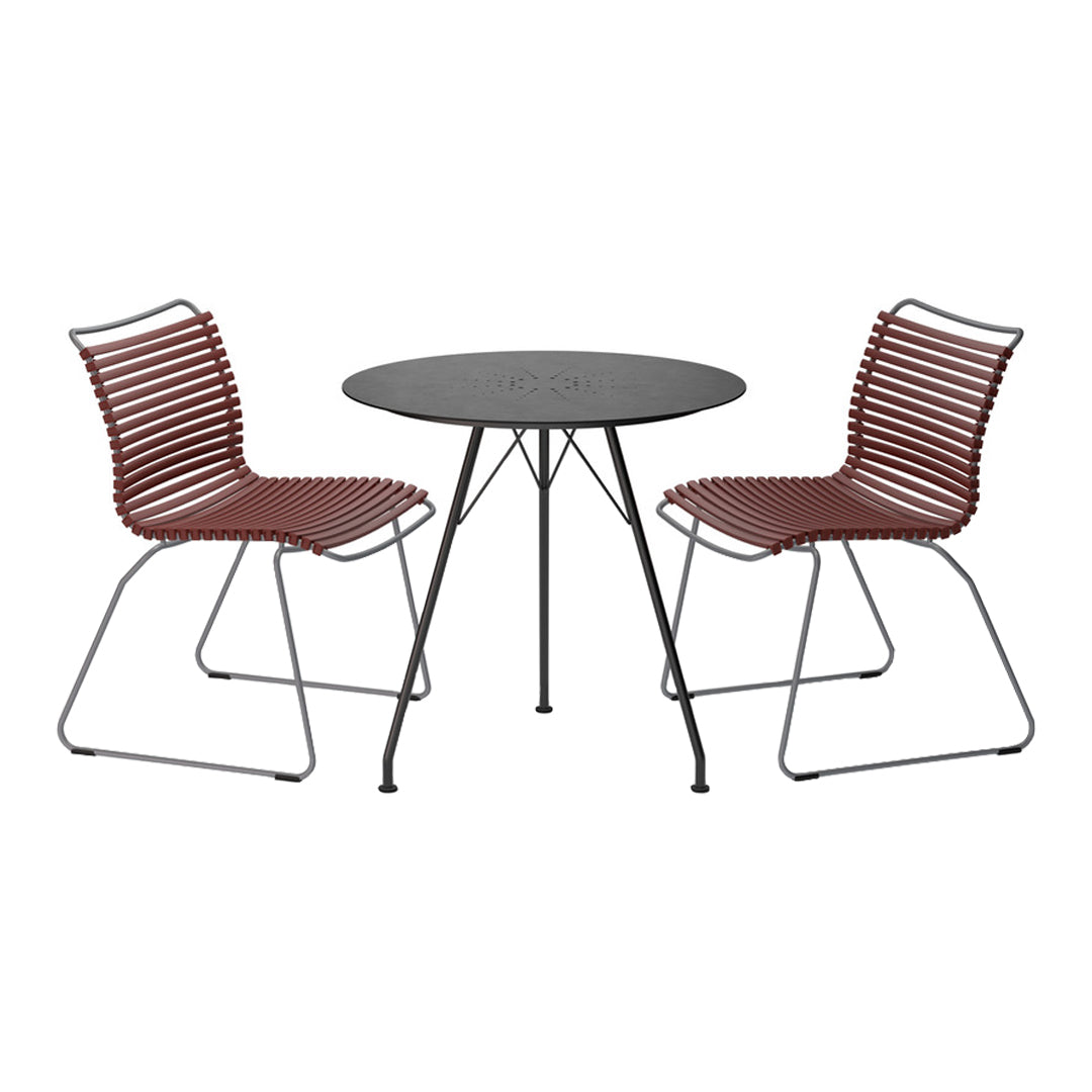Red striped chairs paired with a sleek black round table, perfect for stylish outdoor gatherings.