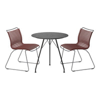 Red striped chairs paired with a sleek black round table, perfect for stylish outdoor gatherings.