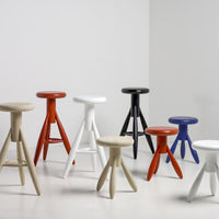 Colorful modern stools in vibrant shades of orange, red, blue, black, white, and beige with unique patterns.