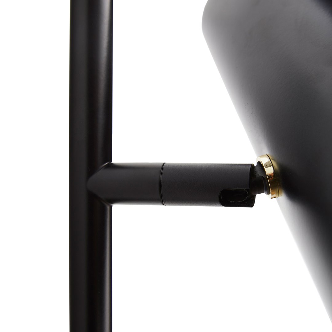 Close-up of a sleek black lamp with a gold accent, showcasing a modern, minimalistic design and smooth finishes.