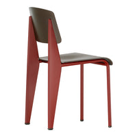 Stylish chair featuring a deep red frame and a contrasting brown seat, showcasing a sleek, modern design.