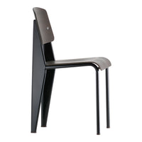 Modern black chair with a sleek design and contrasting dark seat, featuring minimalistic lines and a smooth finish.