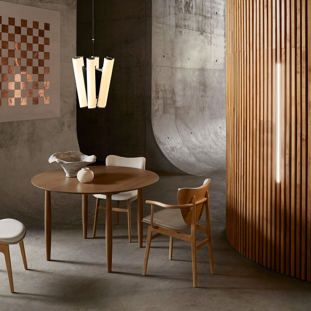 Modern wooden dining set featuring natural tones, sleek curves, and geometric patterns against a neutral backdrop.