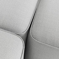 Soft light gray textured fabric with seamless curves and subtle detailing, ideal for modern furniture design.