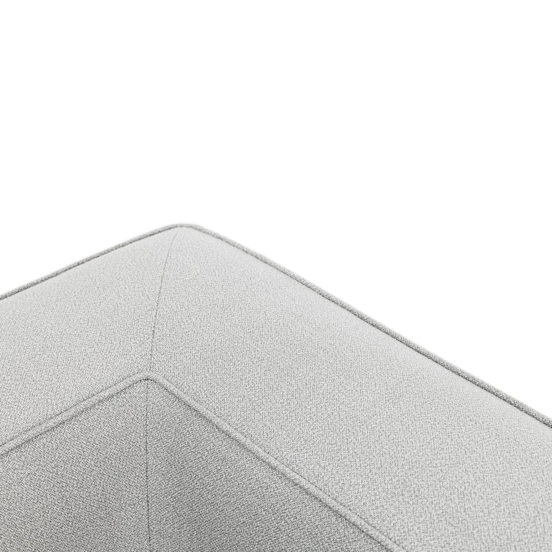 Light gray textured fabric corner detail with subtle stitching patterns, perfect for modern decor.