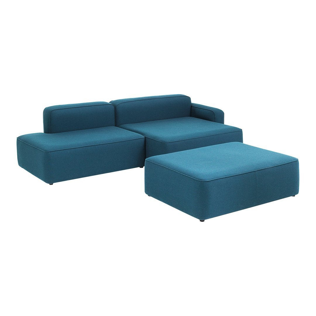 Teal sectional sofa with modern, minimalist design and smooth fabric finish, featuring solid color upholstery.