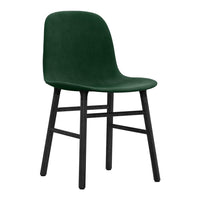 Green velvet chair with a smooth finish and black wooden legs, perfect for modern home decor.