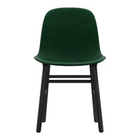 Green velvet chair with a smooth finish and contrasting black wooden legs. Elegant, modern design for any space.