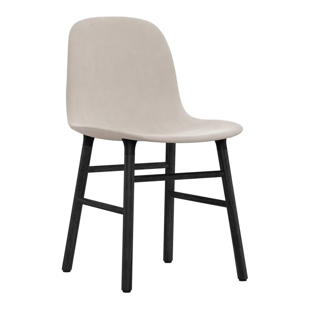 Beige upholstered chair with a smooth finish and black wooden legs, perfect for modern decor.