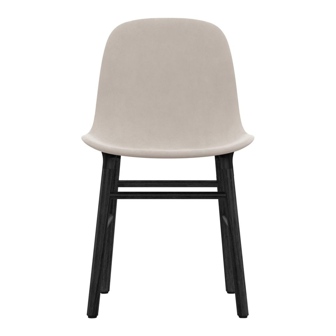 Soft beige chair with a smooth upholstered seat and contrasting black wooden legs, minimalist design.
