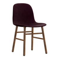 Vibrant burgundy upholstered chair with natural wood legs, sleek design, and minimalist style. Perfect for modern decor.