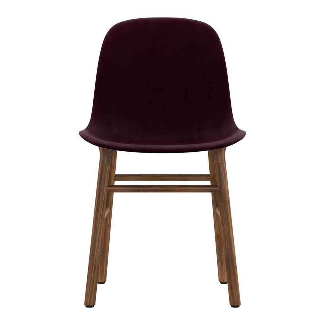 Burgundy velvet chair with wooden legs, featuring a sleek, modern design and minimalistic style. Perfect for any decor.