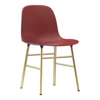 Red molded chair with a sleek gold metal frame, perfect for modern decor. Simple and stylish design with a minimalist aesthetic.