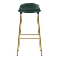 Green bar stool with smooth finish and sleek gold metal legs. Modern aesthetic perfect for contemporary spaces.