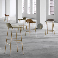 Set of five modern bar stools in neutral tones with sleek gold legs, featuring soft curves and minimalist design.