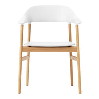 White chair with a smooth, curved back and natural wood legs, showcasing a minimalist and modern design.