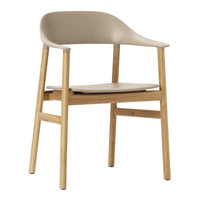 Beige plastic chair with natural wood legs, featuring a minimalist design and smooth contours for modern decor.
